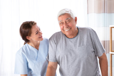 caregiver and the elderly smiling