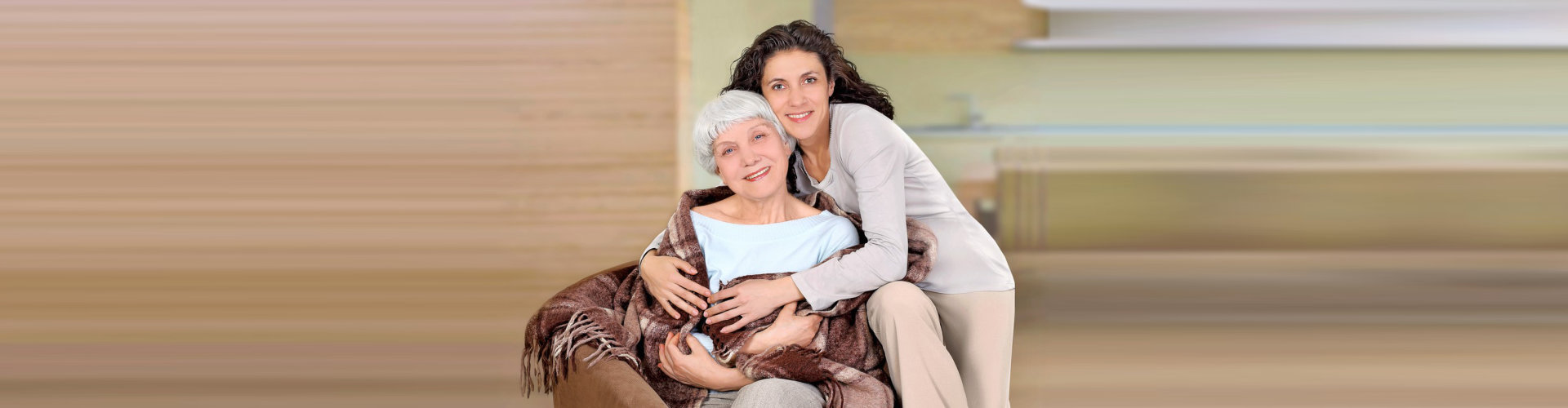caregiver hugging the elderly